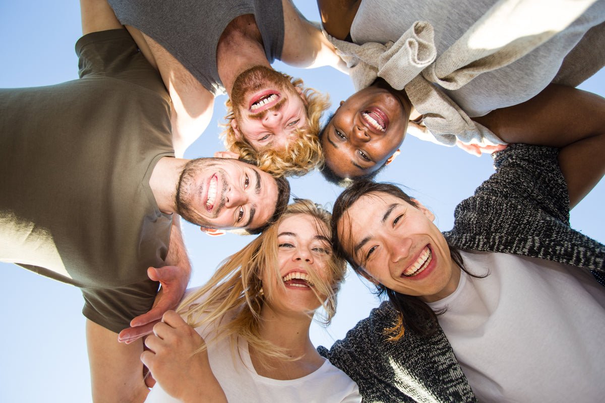 People smiling together in a supportive wellness community